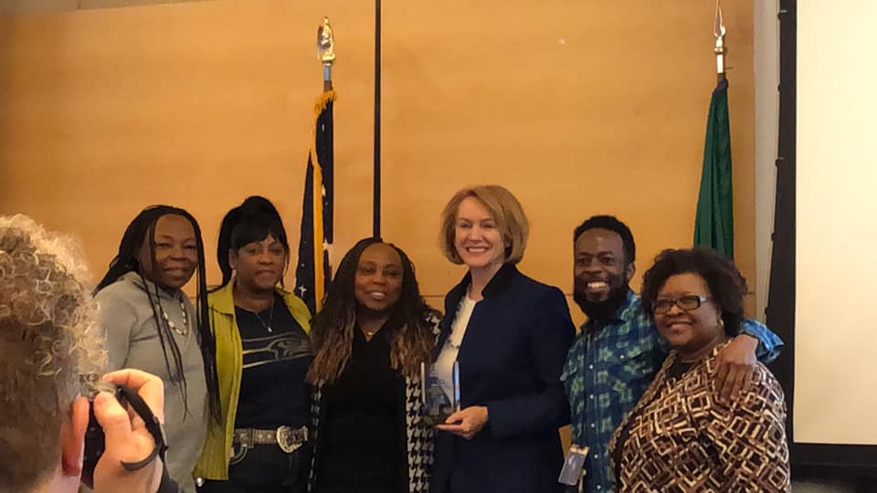 Rev. Dr. Sheila Houston (center) and family members have their photo taken with Seattle Mayor Jenny Durkan (third from right) after Durkan presented Houston with the Anti-Trafficking Trailblazer Award. | Photo courtesy of Superintendent Michael Forney